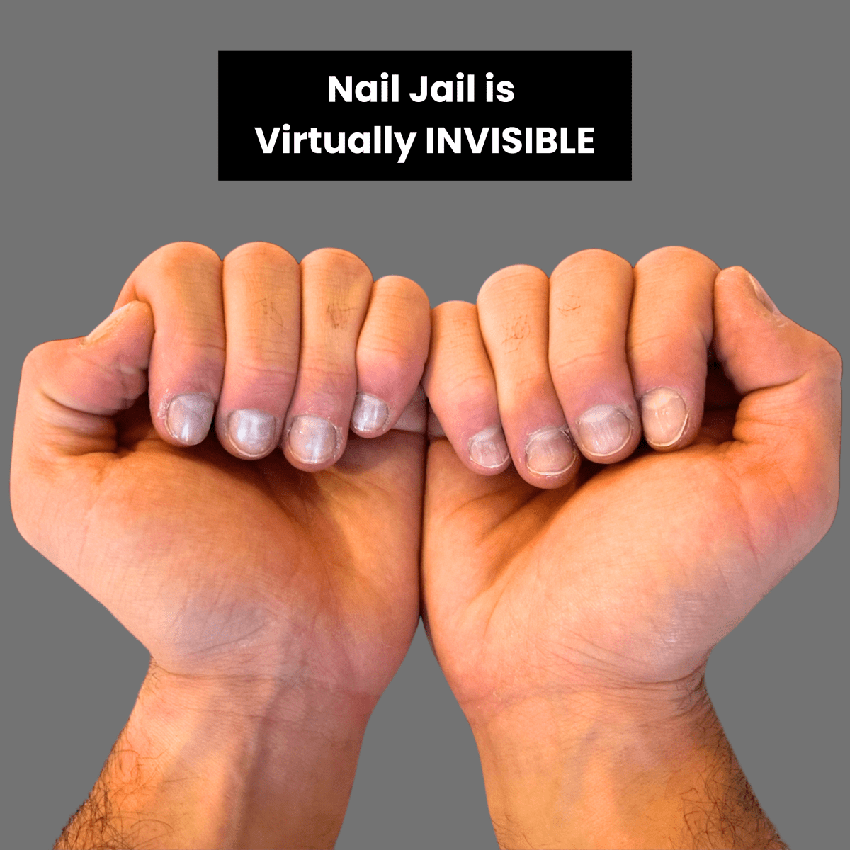 Two fists showcasing the nail biting stopper product's discreet nature. Against a gray background with text 'Nail Jail is Virtually INVISIBLE'.